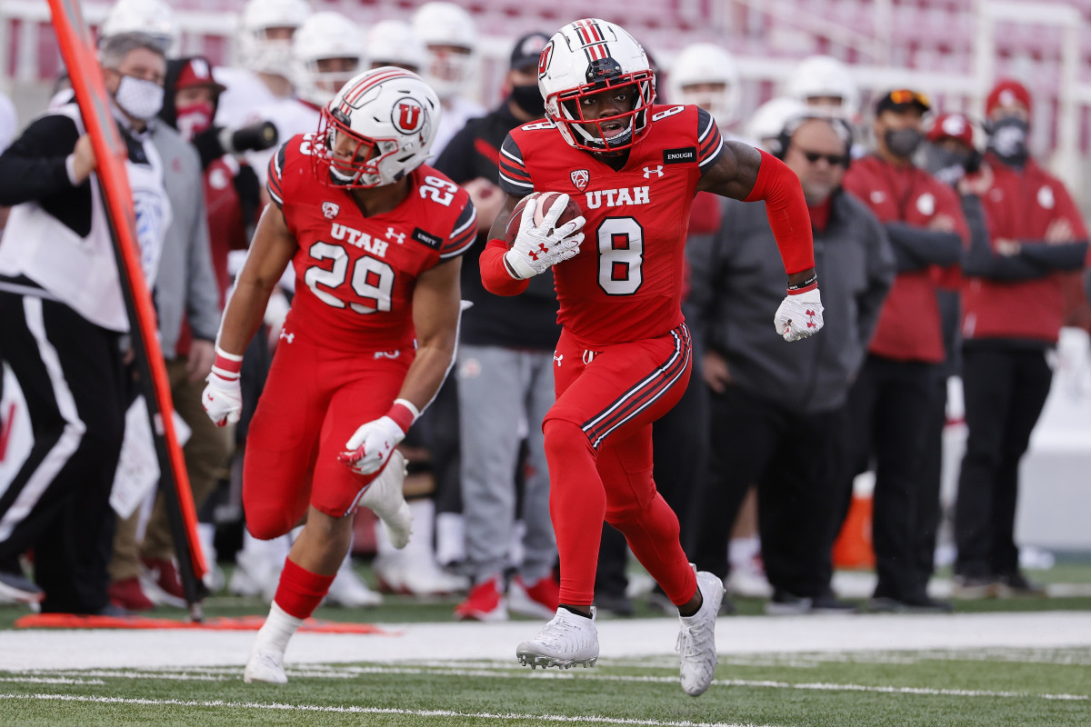 Utah Utes cornerback Clark Phillips III (8) runs back an interception for a touchdown in the fourth quarter against the Washington State Cougars at Rice-Eccles Stadium