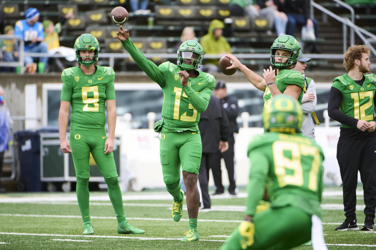 Oregon Ducks quarterback Anthony Brown (13) and quarterback Ty Thompson (17), right, throw the ball before a game against the Oregon State Beavers at Autzen Stadium.