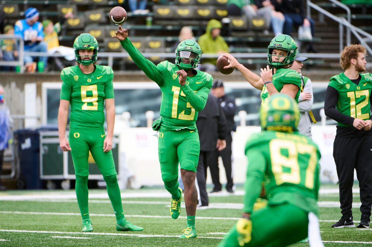 Oregon Ducks quarterback Anthony Brown (13) and quarterback Ty Thompson (17), right, throw the ball before a game against the Oregon State Beavers at Autzen Stadium.