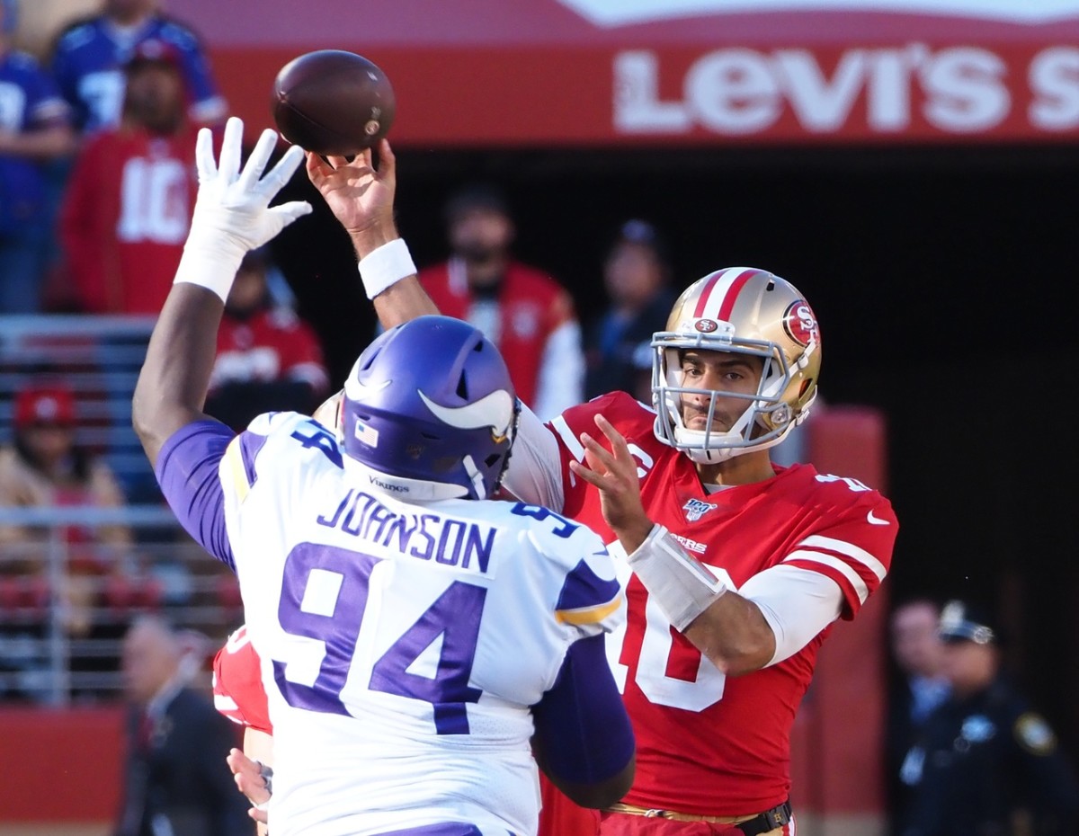 Jan 11, 2020; San Francisco 49ers quarterback Jimmy Garoppolo (10) throws under pressure from Minnesota Vikings defensive tackle Jaleel Johnson (94). Mandatory Credit: Kelley L Cox-USA TODAY Sports
