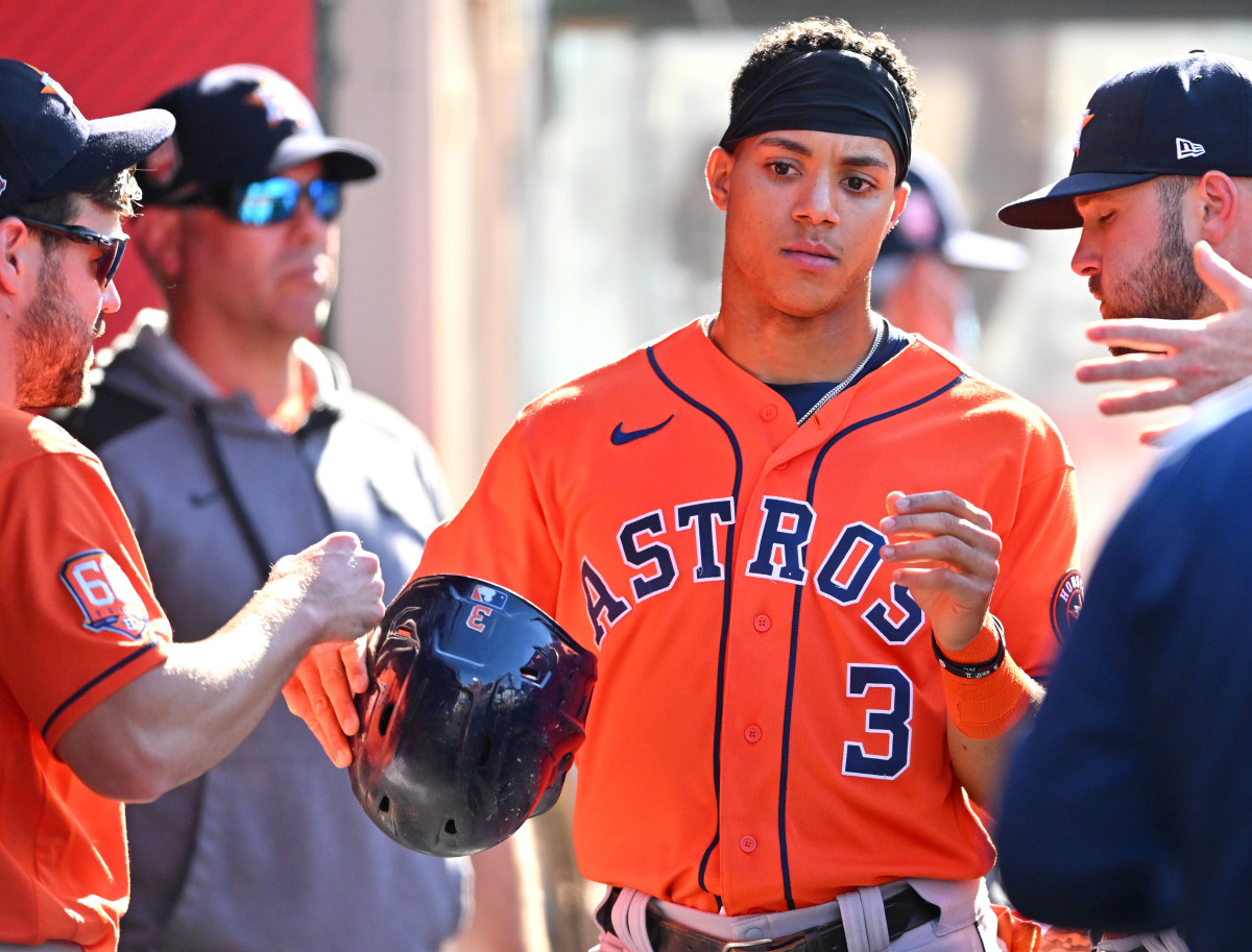 Jeremy Peña is greeting in the dugout after scoring a run in the first.
