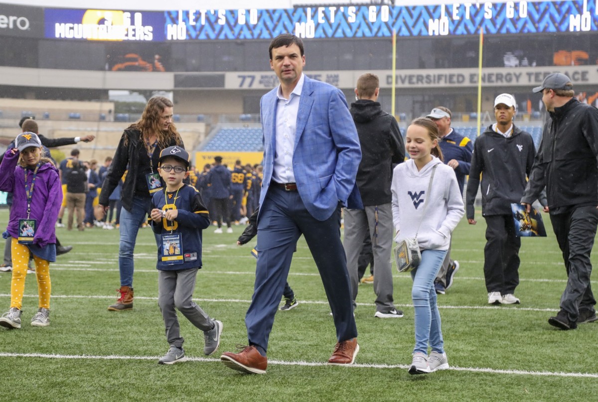 Oct 30, 2021; Morgantown, West Virginia, USA; West Virginia Mountaineers head coach Neal Brown walks into the stadium with his kids prior to their game against the Iowa State Cyclones at Mountaineer Field at Milan Puskar Stadium.