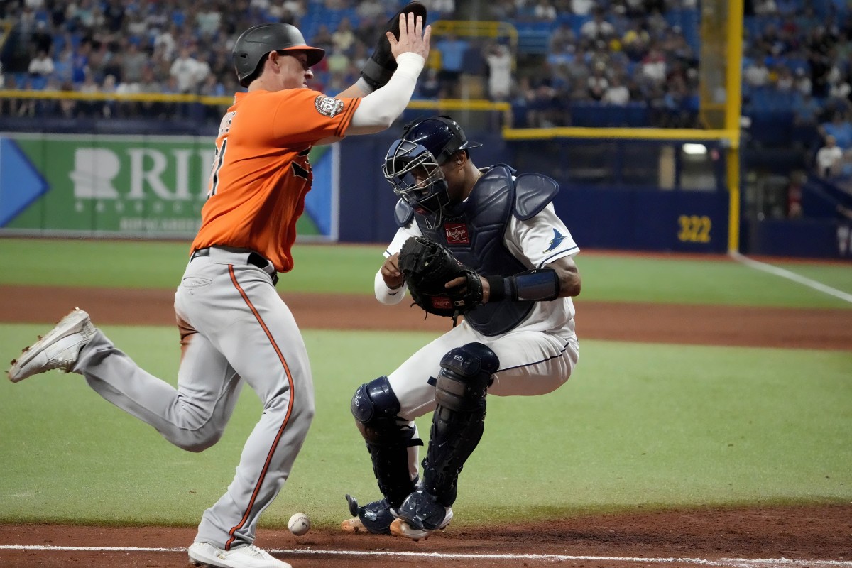 Baltimore Orioles left fielder Austin Hays (21) scores on a sacrifice fly hit by Baltimore Orioles catcher Adley Rutschman (35) to tie the game in the ninth inning at Tropicana Field. (Dave Nelson-USA TODAY Sports)