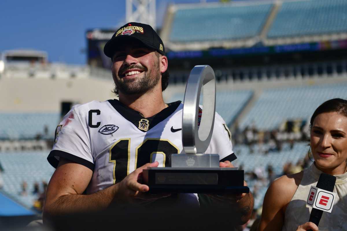 Wake Forest Demon Deacons quarterback Sam Hartman (10) holds up the MVP trophy after the game Friday, Dec. 31, 2021 at TIAA Bank Field in Jacksonville. The Wake Forest Demon Deacons and the Rutgers Scarlet Knights faced each other in the 2021 TaxSlayer Gator Bowl. Wake Forest defeated Rutgers 38-10.
