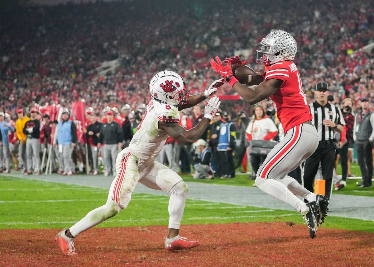 Ohio State Buckeyes wide receiver Marvin Harrison Jr. (18) hauls in a touchdown under pressure from Utah Utes cornerback Clark Phillips III (8) during the fourth quarter of the 108th Rose Bowl Game between the Ohio State Buckeyes and the Utah Utes at the Rose Bowl.