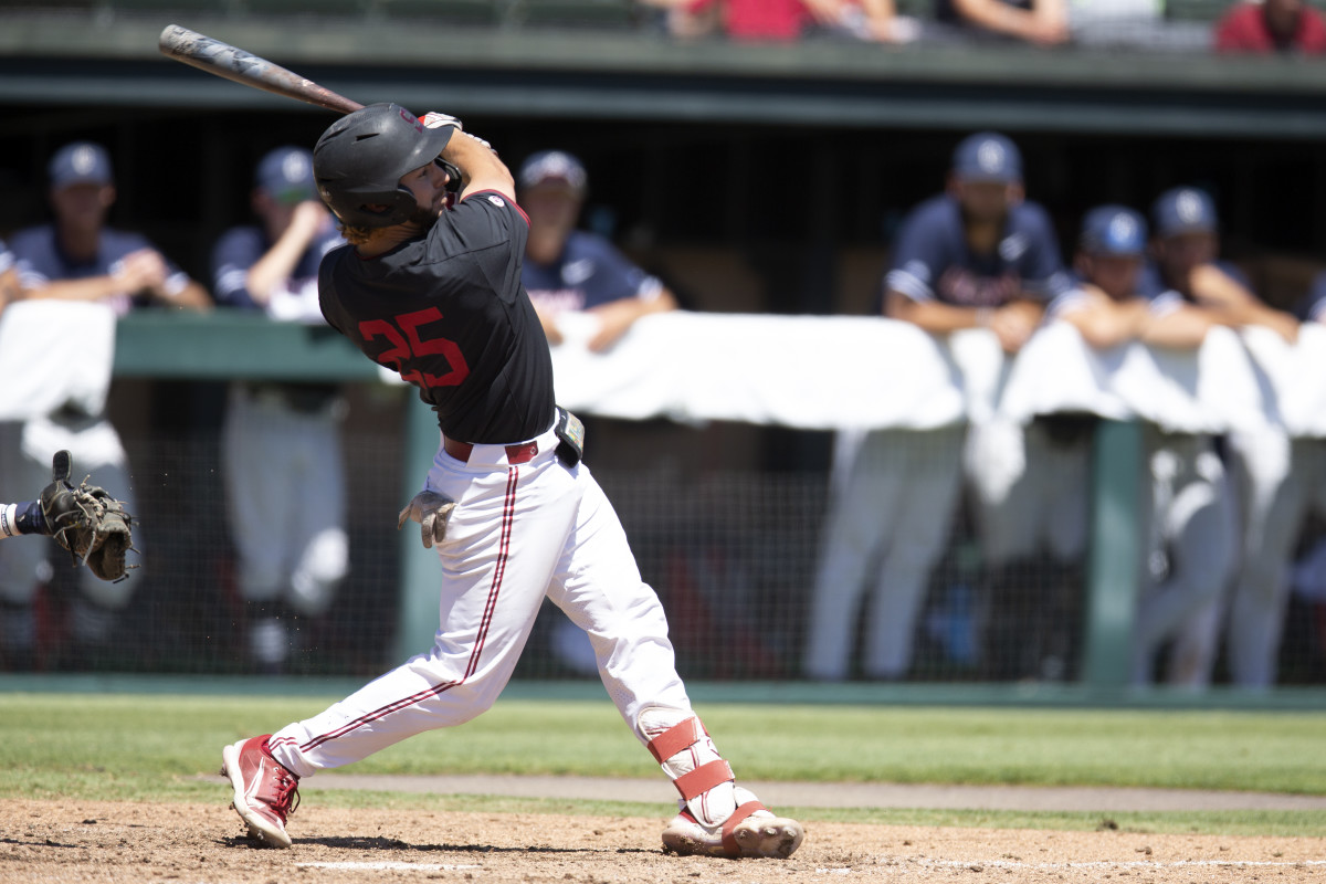 Stanford's Kody Huff follows the flight of his grand slam against Connecticut during the fourth inning of an NCAA college baseball tournament super regional game, Monday, June 13, 2022, in Stanford, Calif.