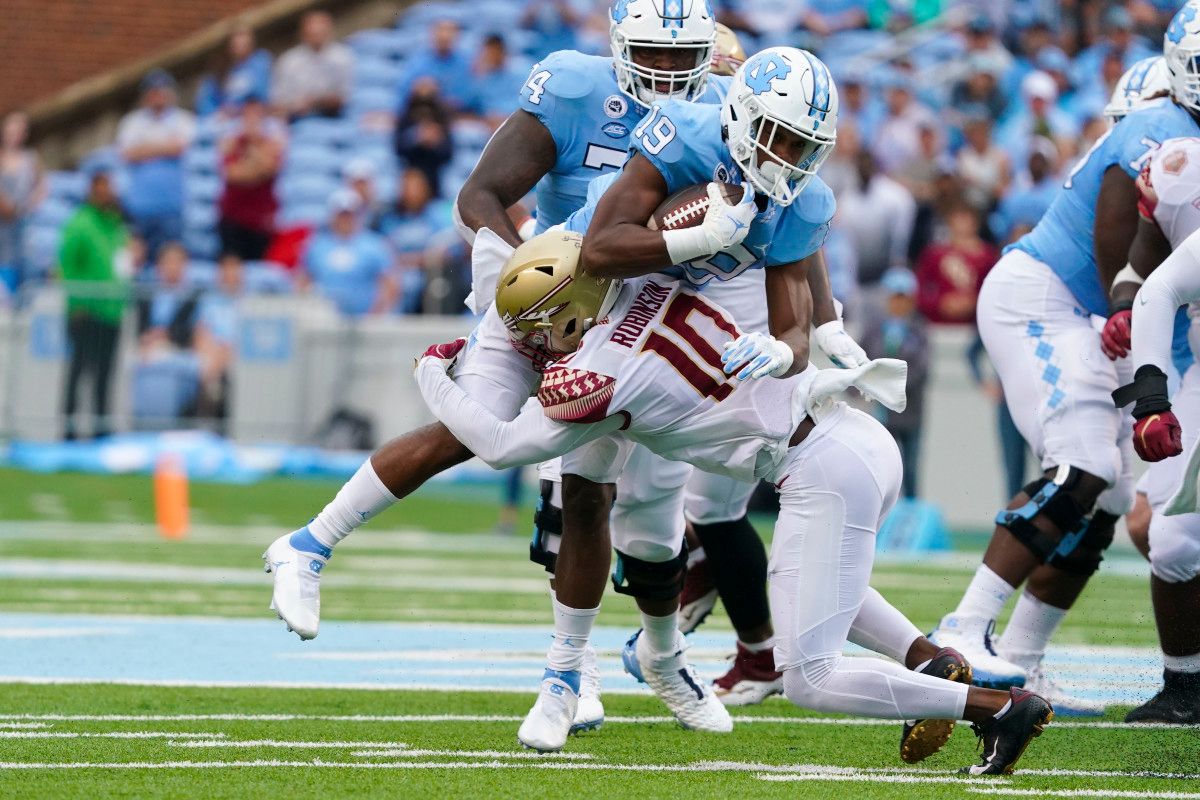 Florida State Seminoles defensive back Jammie Robinson (10) stops the run against North Carolina Tar Heels running back Ty Chandler (19) during the first half at Kenan Memorial Stadium.