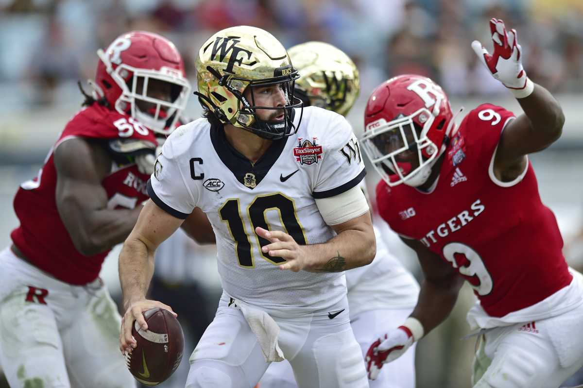 Wake Forest quarterback Sam Hartman (10) is pressured in the pocket by Rutgers during the second quarter at the Gator Bowl during an NCAA College football game, Friday, Dec. 31, 2021 in Jacksonville, Fla.