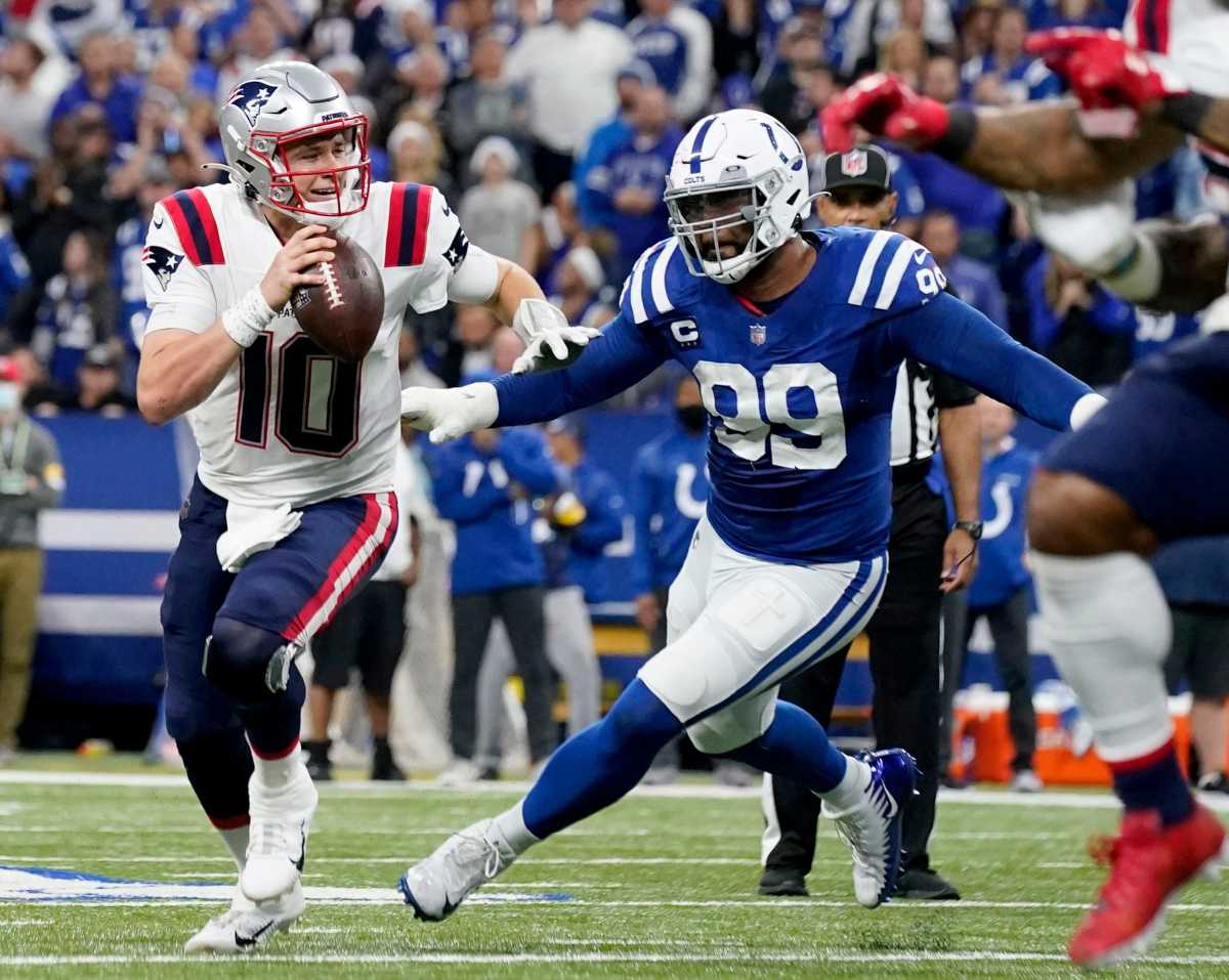 Indianapolis Colts defensive tackle DeForest Buckner (99) chases after New England Patriots quarterback Mac Jones (10) as he scrambles in the pocket Saturday, Dec. 18, 2021, during a game against the New England Patriots at Lucas Oil Stadium in Indianapolis.