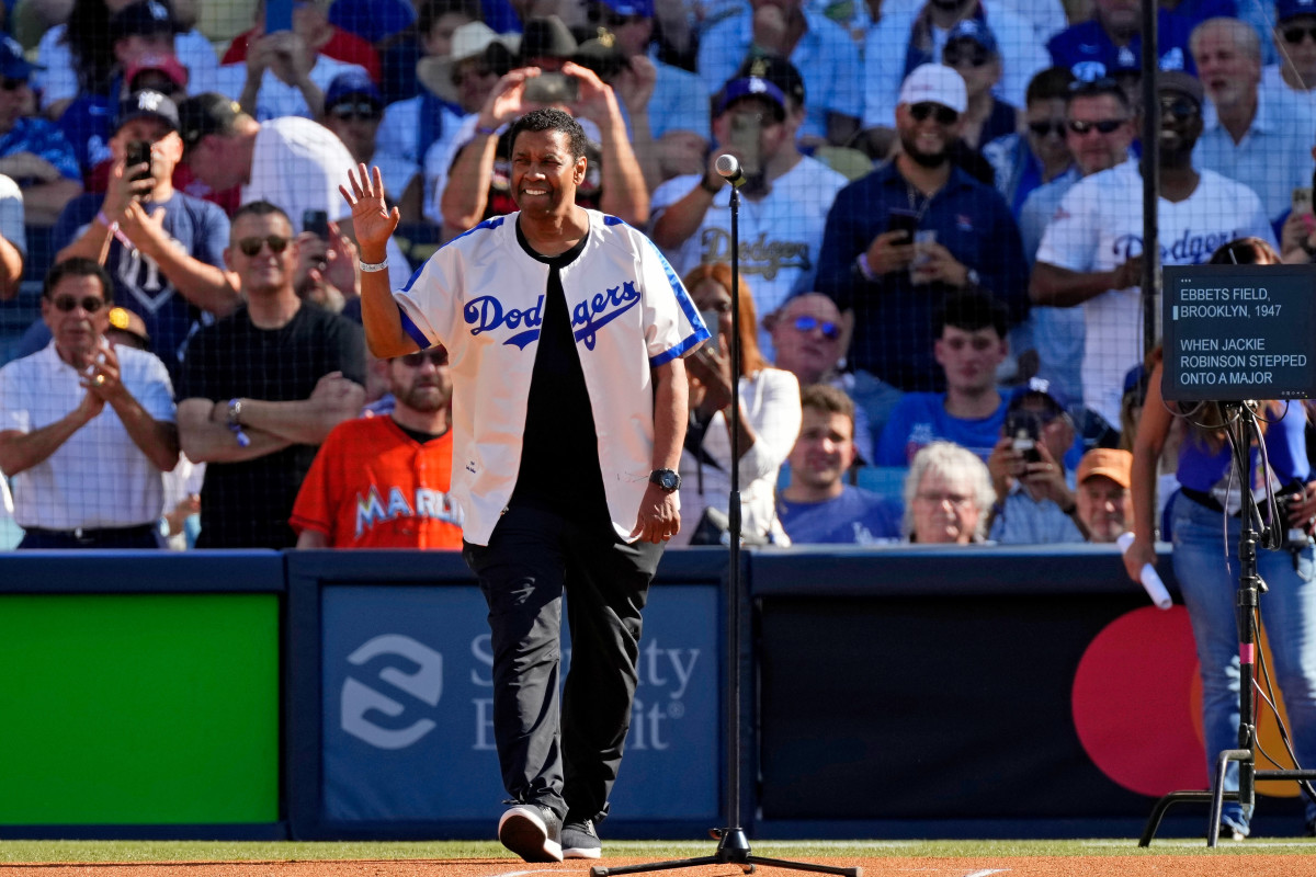 Denzel Washington waves to fans at the MLB All-Star game.