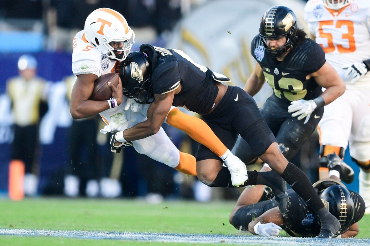 Tennessee quarterback Hendon Hooker (5) is tackled by Purdue linebacker/safety Jalen Graham (6) at the 2021 Music City Bowl NCAA college football game at Nissan Stadium in Nashville, Tenn. on Thursday, Dec. 30, 2021.