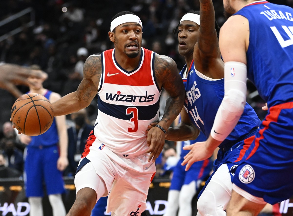 Washington Wizards guard Bradley Beal (3) dribbles as LA Clippers guard Terance Mann (14) defends during the first half at Capital One Arena.