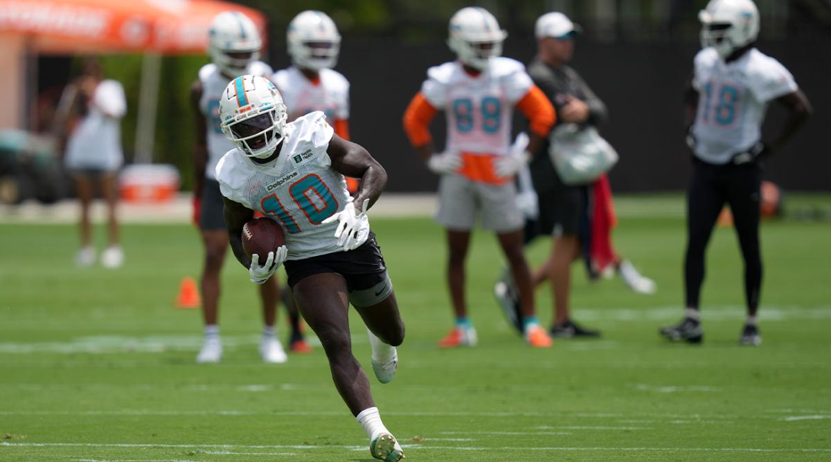 May 24, 2022; Miami Gardens, FL, USA; Miami Dolphins wide receiver Tyreek Hill (10) runs with the ball during OTA practice at Baptist Health Training Complex.