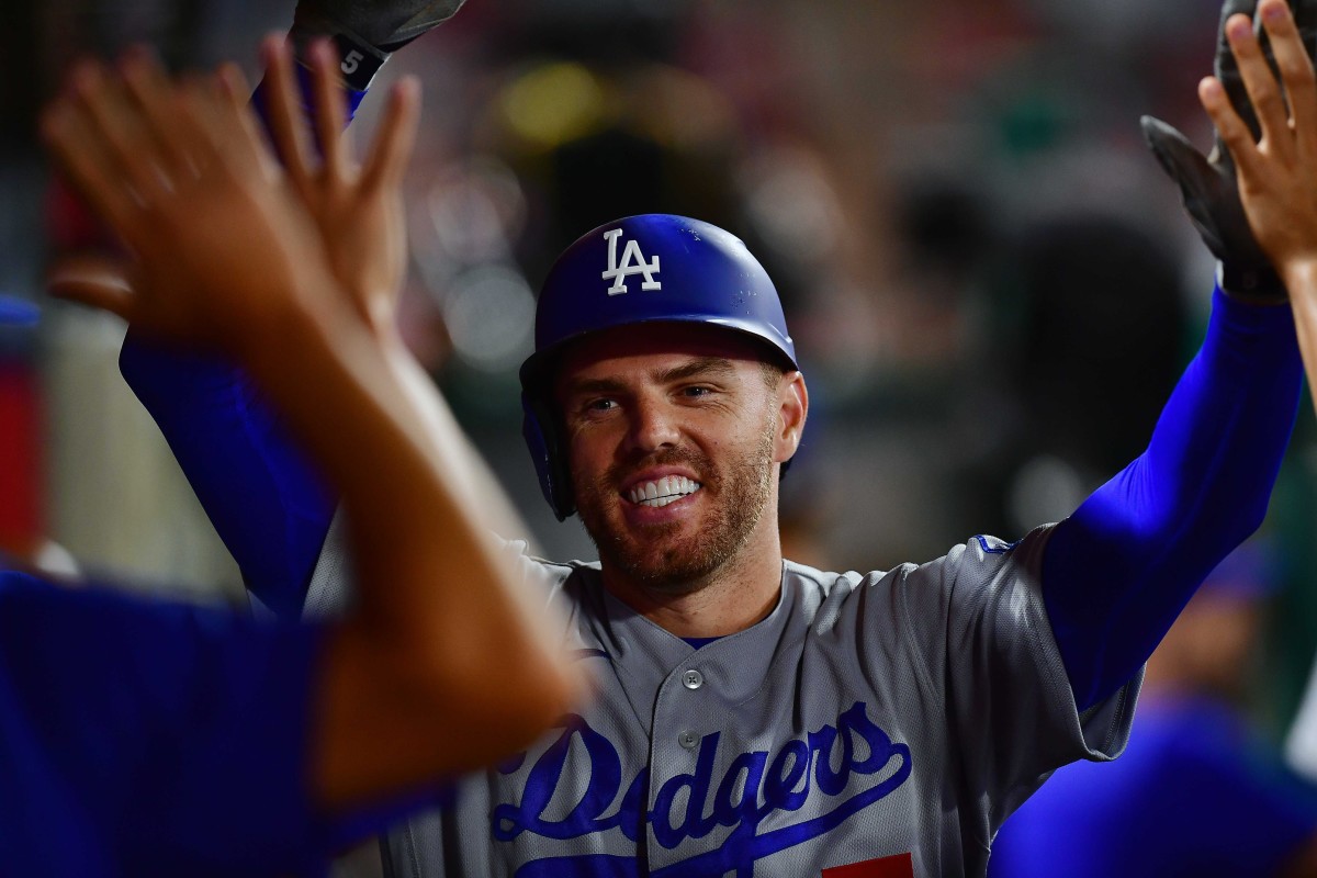 Los Angeles Dodgers first baseman Freddie Freeman (5) is greeted after hitting a solo home run against the Los Angeles Angels during the fifth inning at Angel Stadium. (Gary A. Vasquez-USA TODAY Sports)