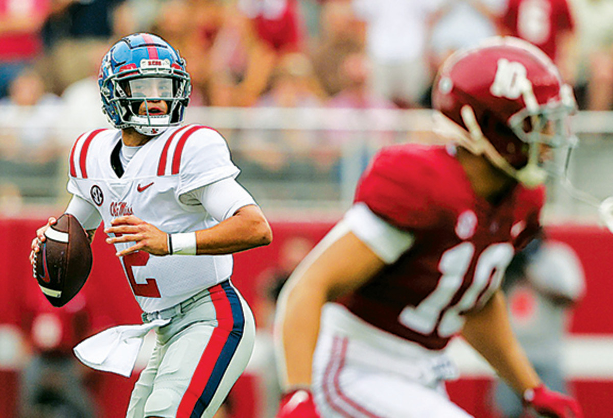 Mississippi Rebels quarterback Matt Corral (2) rolls out to pass against the Alabama Crimson Tide during the first half of an NCAA college football game at Bryant-Denny Stadium.