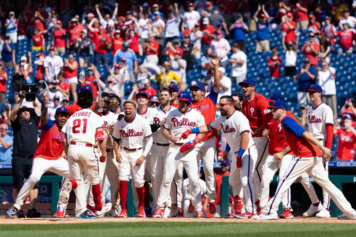 Garrett Stubbs is mobbed at home plate by his teammates after a walk-off home run.