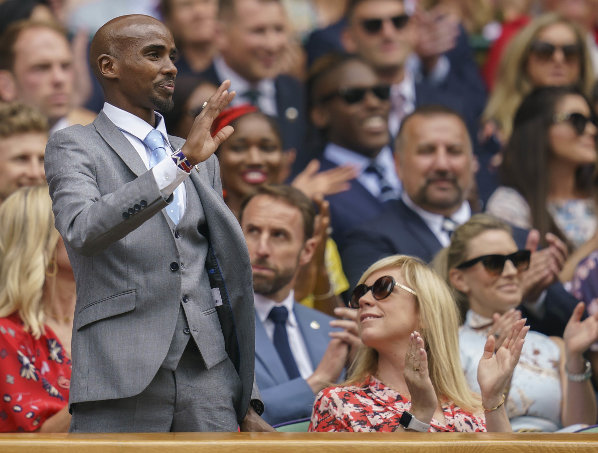 British track star Mo Farah waves to the crowd at Wimbledon in 2019.