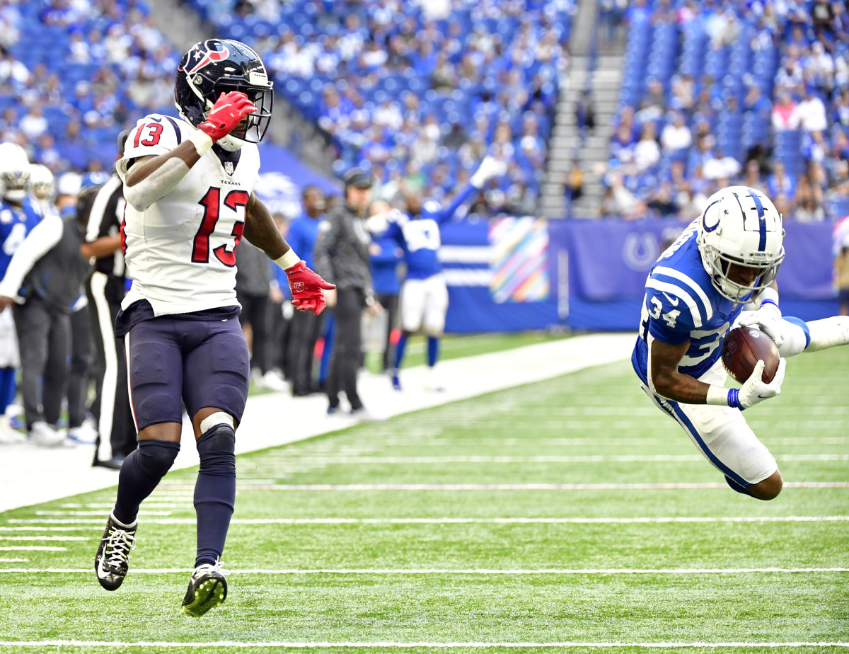 Oct 17, 2021; Indianapolis, Indiana, USA; Houston Texans wide receiver Brandin Cooks (13) watches as Indianapolis Colts cornerback Isaiah Rodgers (34) intercepts a ball meant for him during the second half at Lucas Oil Stadium. The Colts win 31-3.