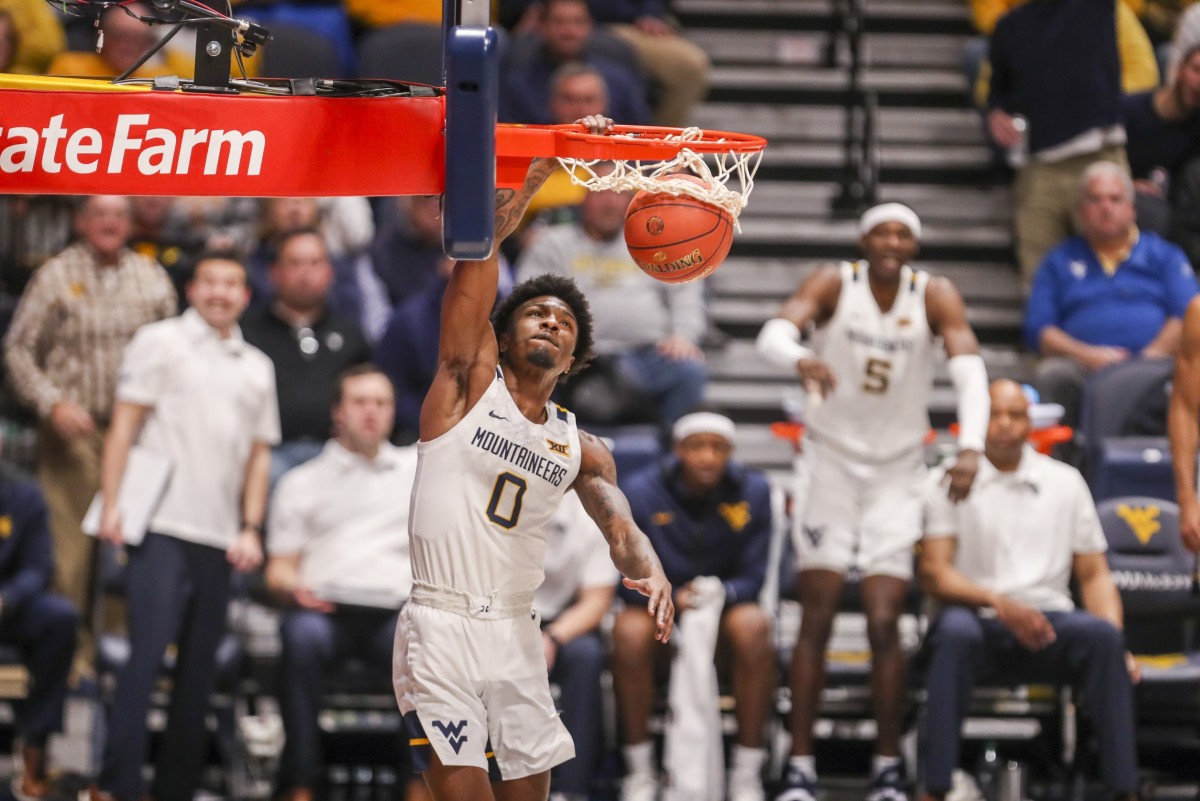 Feb 8, 2022; Morgantown, West Virginia, USA; West Virginia Mountaineers guard Kedrian Johnson (0) dunks the ball during the second half against the Iowa State Cyclones at WVU Coliseum.