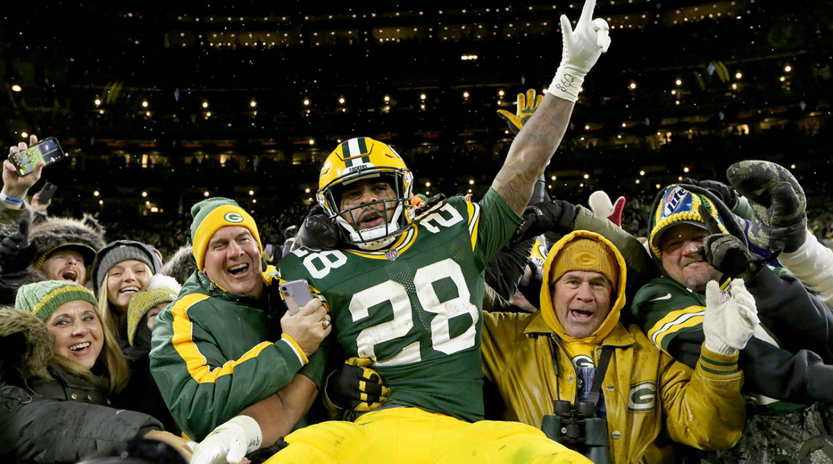 AJ Dillon celebrates scoring his first of two rushing touchdowns with a Lambeau leap.