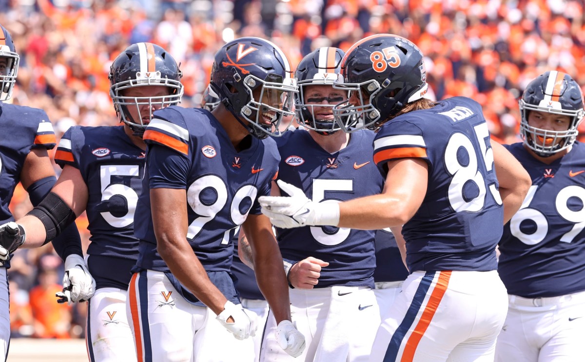 Virginia Cavaliers receiver Keytaon Thompson and tight end Grant Misch celebrate a touchdown against Illinois.