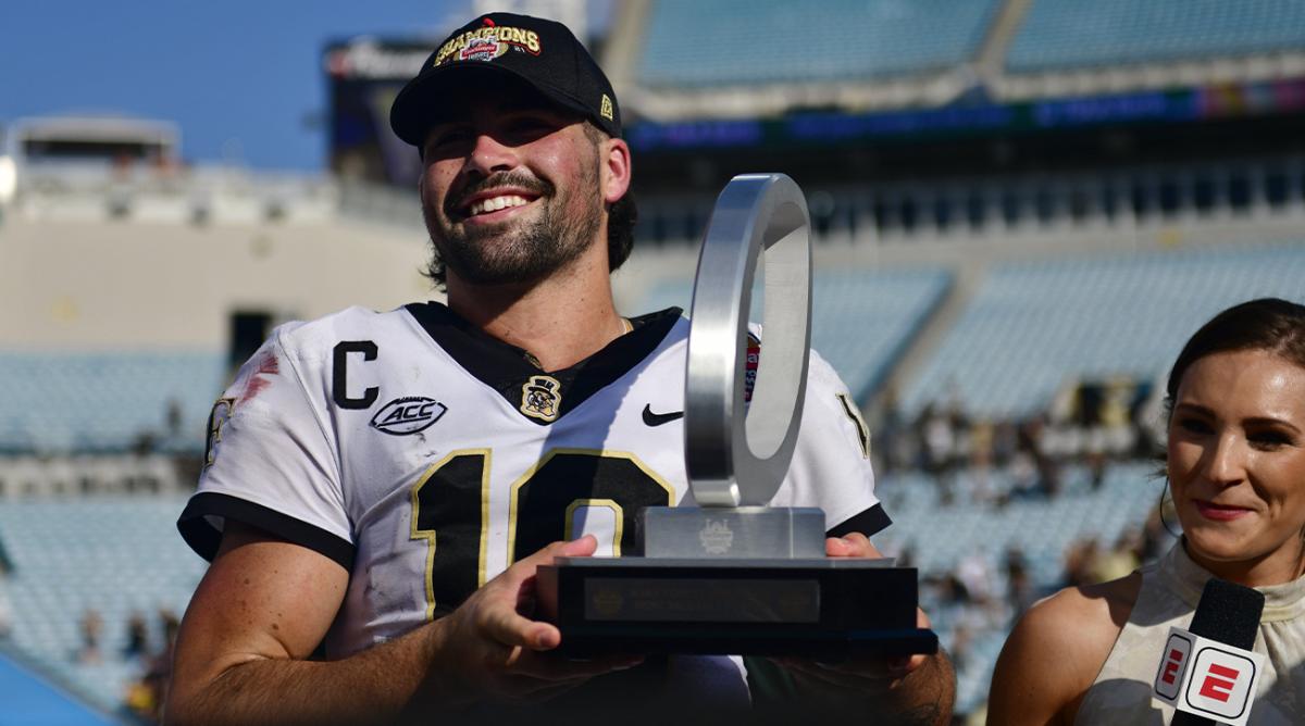 Wake Forest Demon Deacons quarterback Sam Hartman (10) holds up the MVP trophy after the game Friday, Dec. 31, 2021 at TIAA Bank Field in Jacksonville. The Wake Forest Demon Deacons and the Rutgers Scarlet Knights faced each other in the 2021 TaxSlayer Gator Bowl. Wake Forest defeated Rutgers 38-10.