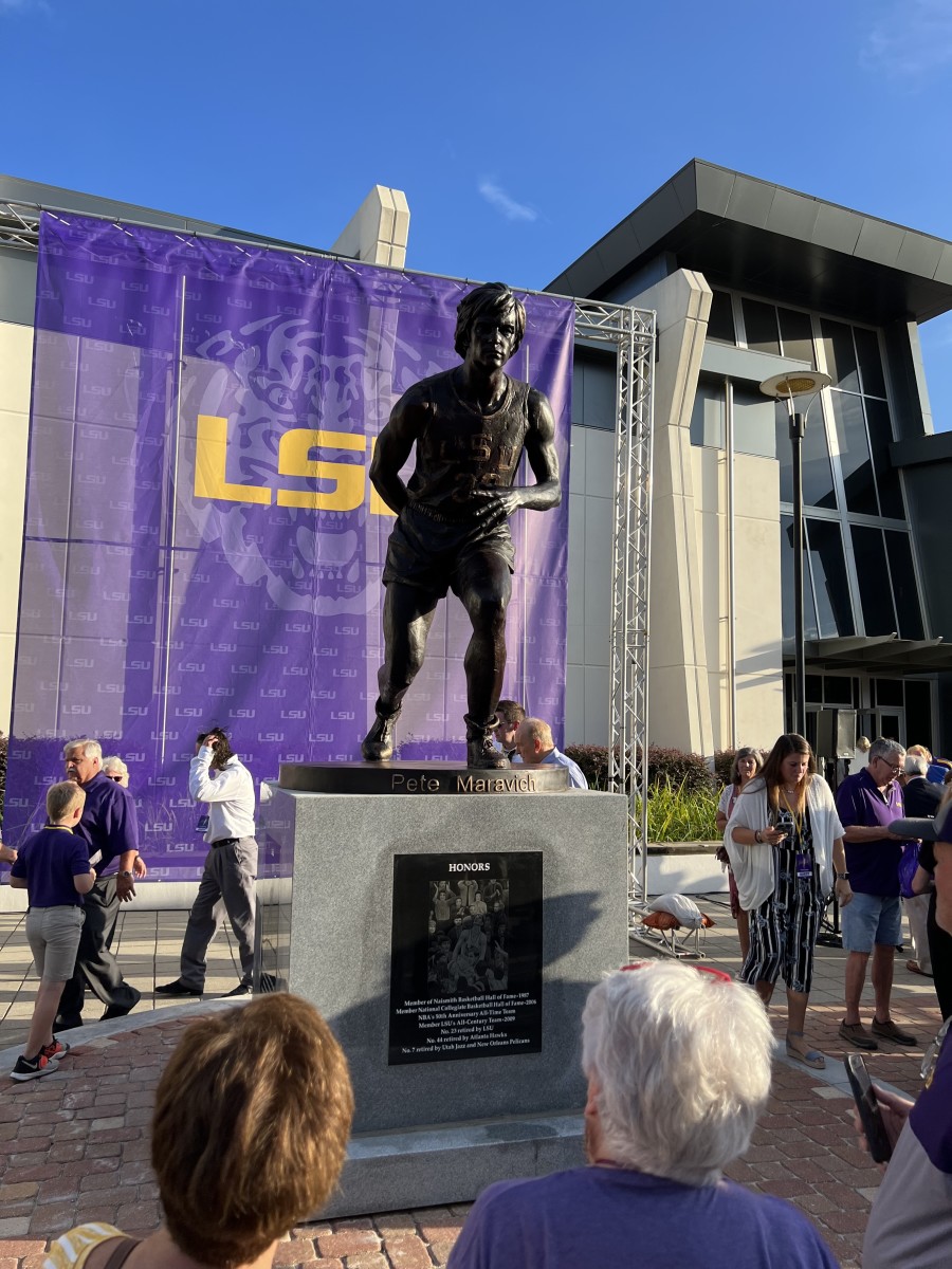 Pete Maravich's statue, posing as his signature behind-the-back pass, is unveiled on July 25, 2022. 