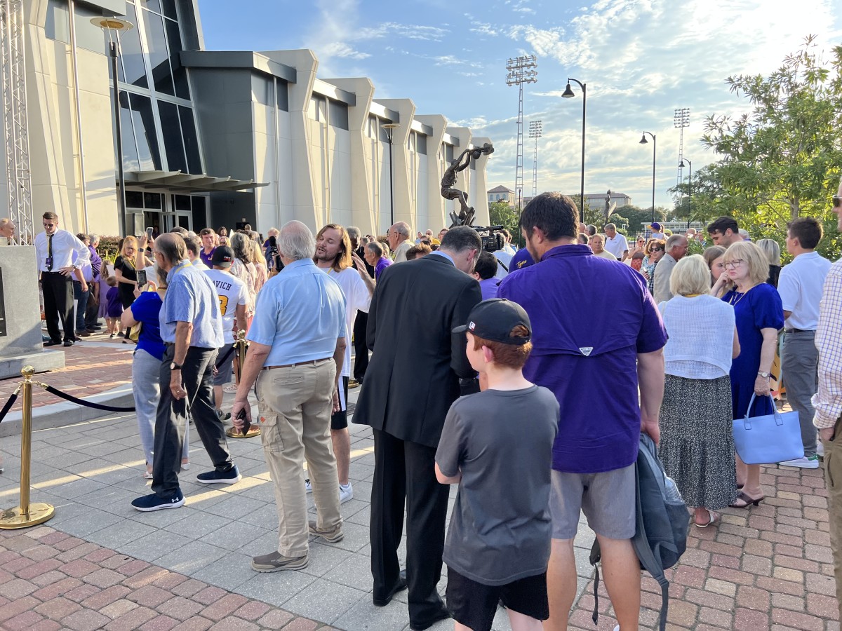 LSU Men's Basketball Head Coach Matt McMahon, pictured in the suit, signs autographs and takes pictures with fans following the unveiling of Pete Maravich's statue on July 25, 2022. 