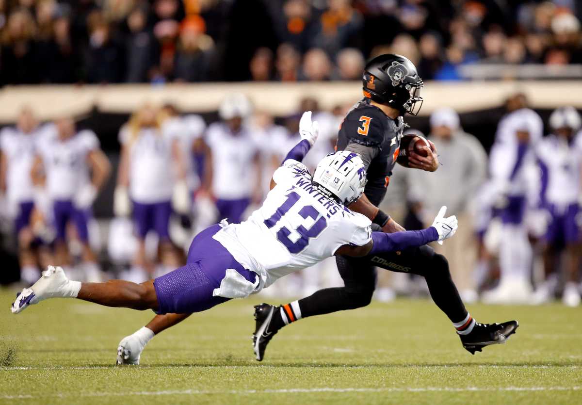 Oklahoma State's Spencer Sanders (3) is tackled by TCU's Dee Winters in the second quarter during the college football game between the Oklahoma State Cowboys and TCU Horned Frogs at Boone Pickens Stadium in Stillwater, Okla., Saturday, Nov. 13, 2021.
