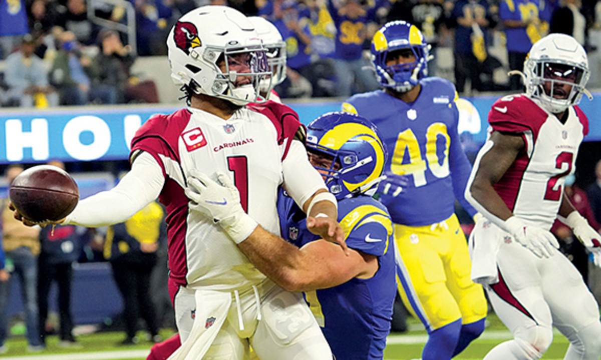 Arizona Cardinals quarterback Kyler Murray (1) throws the ball while brought down by Los Angeles Rams linebacker Anthony Hines III (57) during the second quarter of the NFC Wild Card playoff game.