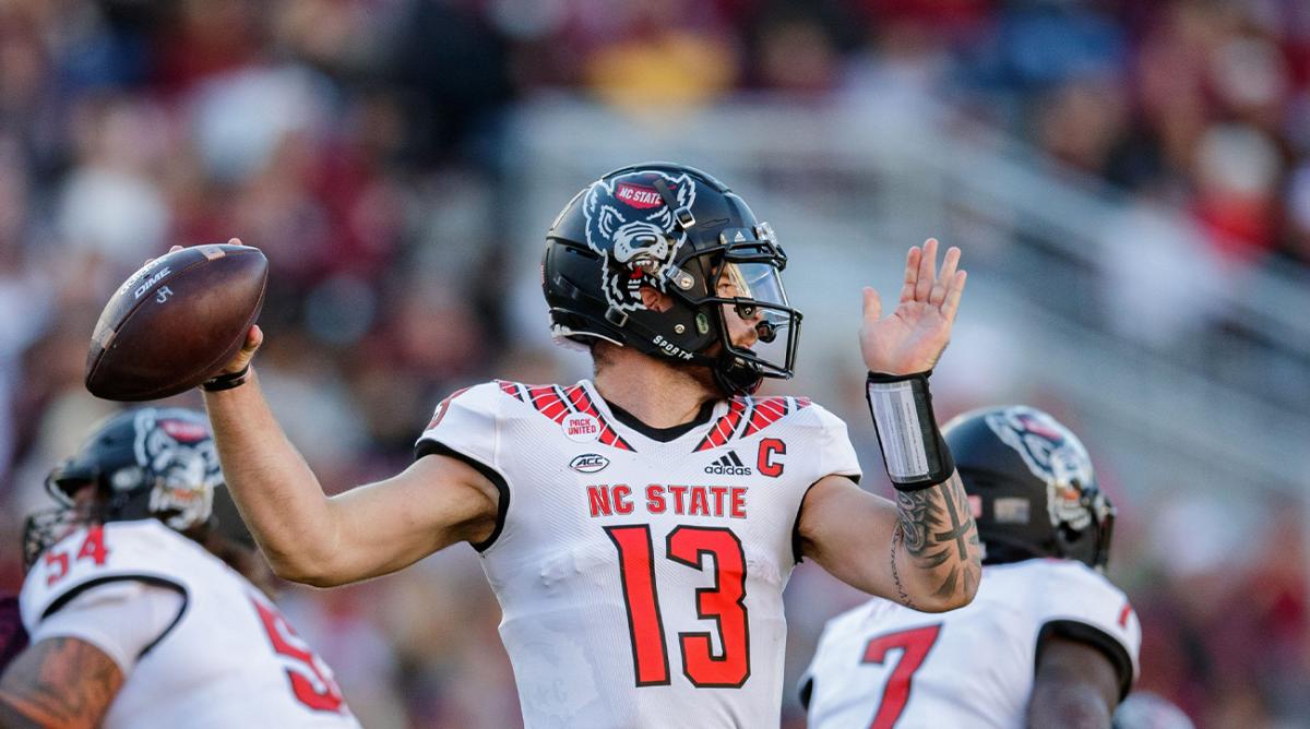 North Carolina State Wolfpack quarterback Devin Leary (13) passes to a teammate. The North Carolina State Wolfpack lead the Florida State Seminoles 14-0 at the half Saturday, Nov. 6, 2021.