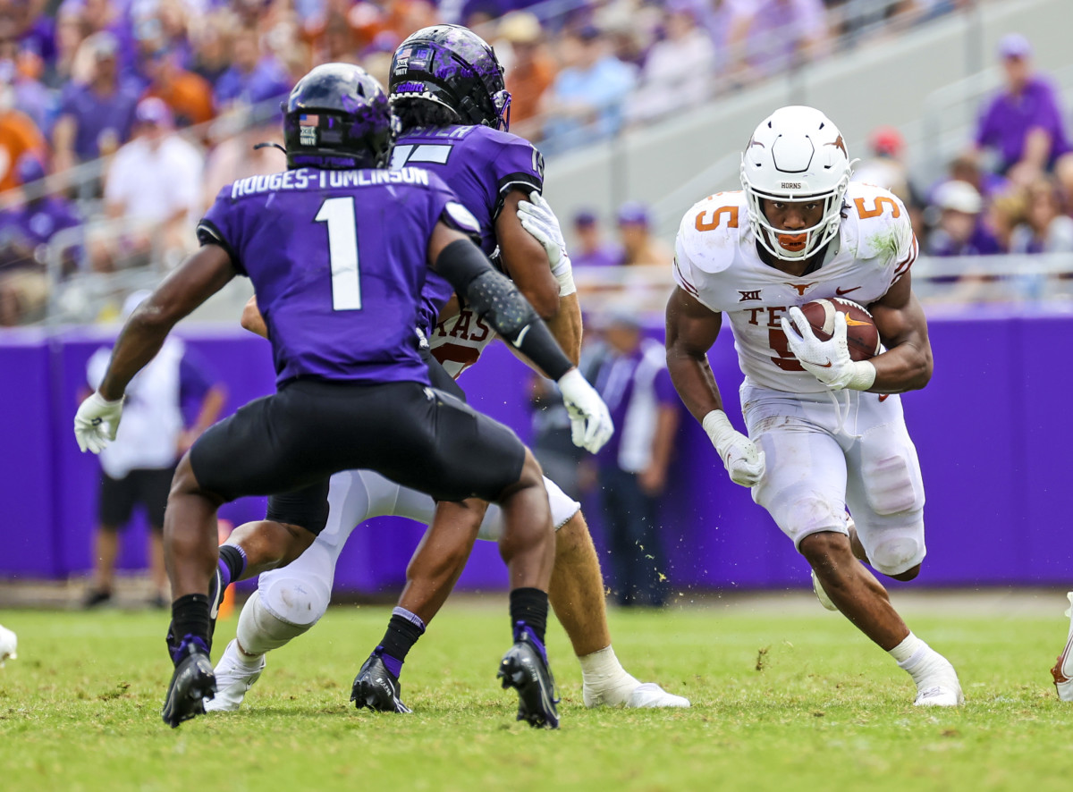 Oct 2, 2021; Fort Worth, Texas, USA; Texas Longhorns running back Bijan Robinson (5) runs with the ball as TCU Horned Frogs cornerback Tre'Vius Hodges-Tomlinson (1) defends during the second half at Amon G. Carter Stadium.