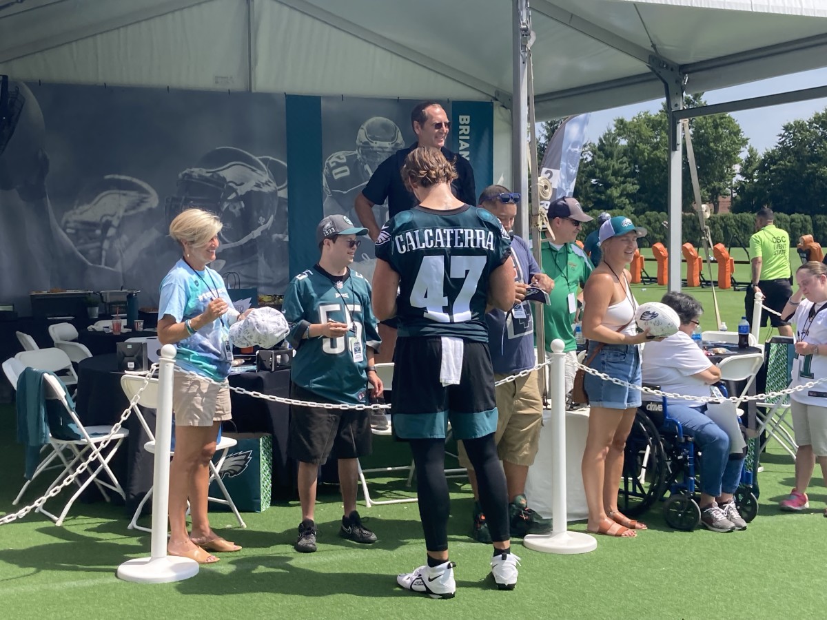 Eagles TE Grant Calcaterra signs autographs for fans following July 27, 2022, practice