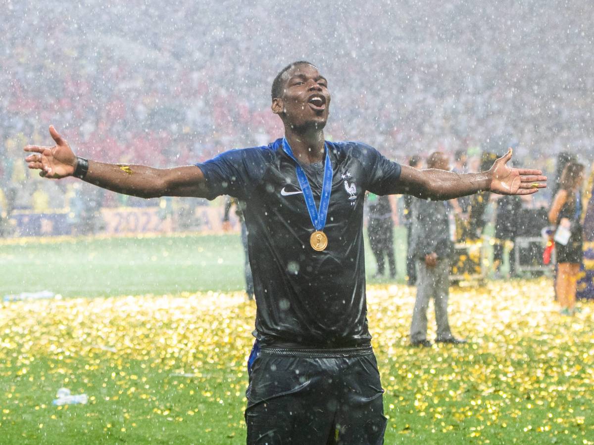 Paul Pogba pictured celebrating in the rain while wearing his winners medal after helping France beat Croatia in the 2018 World Cup final
