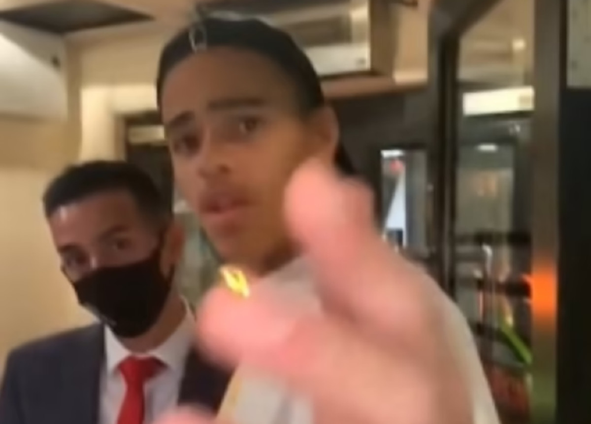 Mason Greenwood waves his hand in front of a cameraphone after being goaded by a man filming him