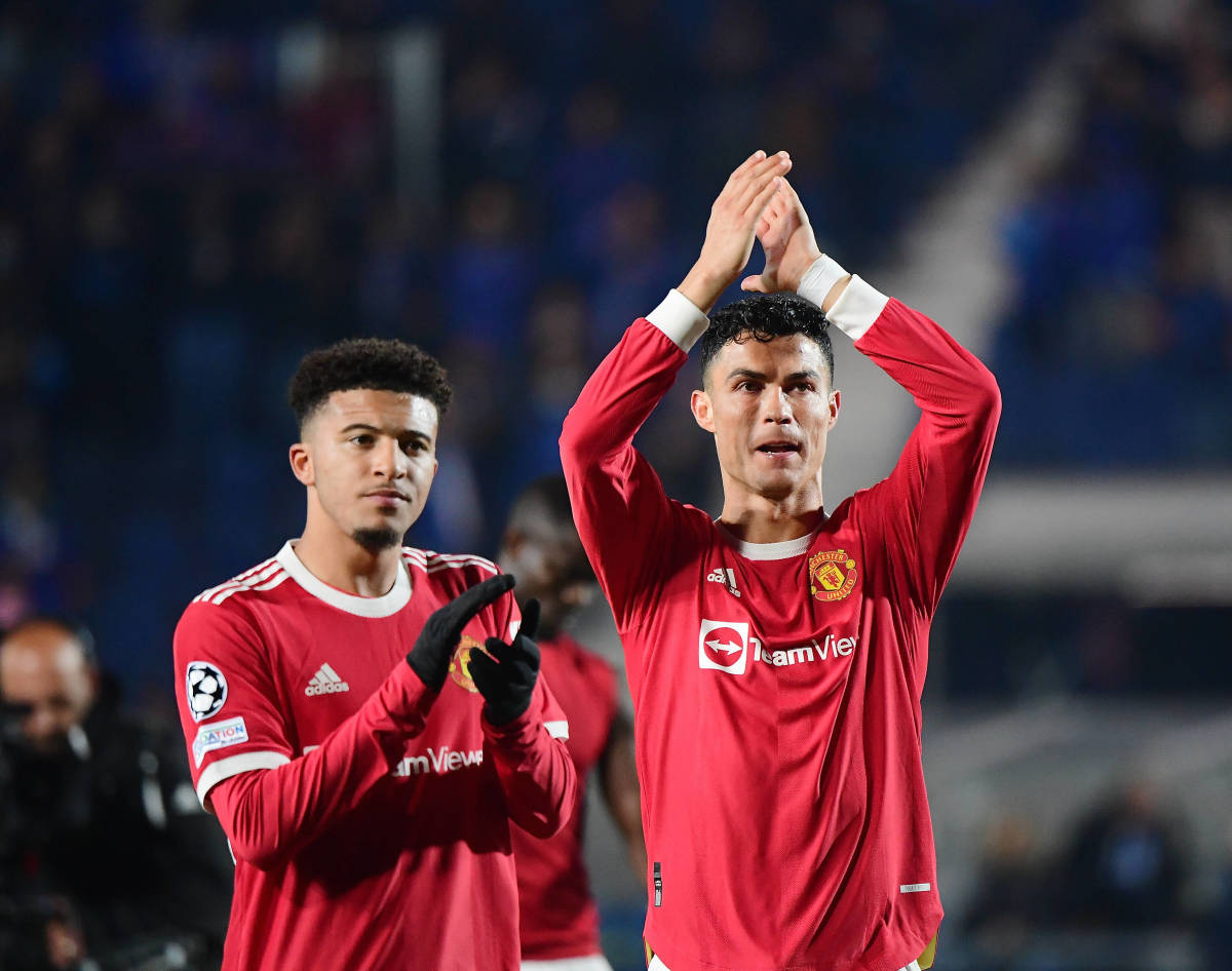 Cristiano Ronaldo (right) and Jadon Sancho applaud Manchester United fans after a game against Atalanta in 2021