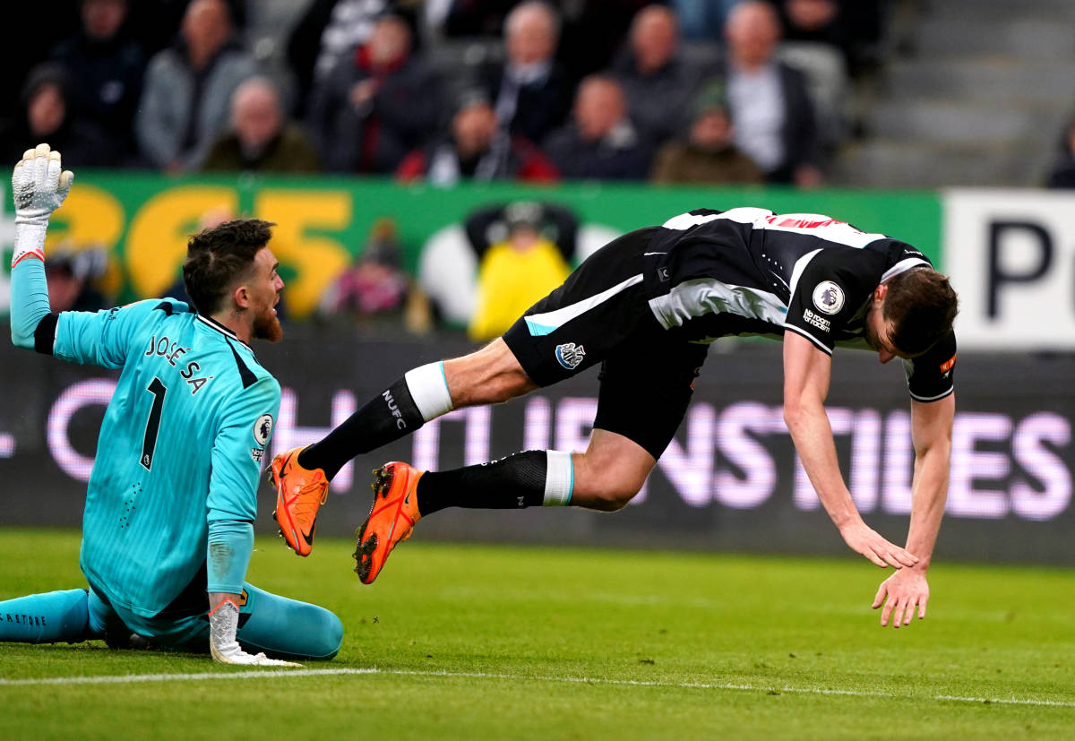 Newcastle striker Chris Wood falls after being fouled by Wolves goalkeeper Jose Sa during a Premier League game in April 2022