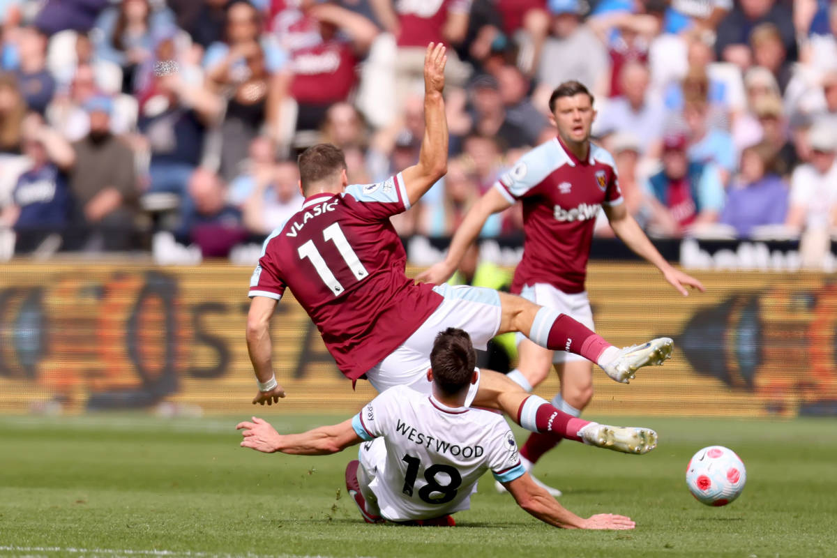 West Ham's Nikola Vlasic falls over Ashley Westwood as the Burnley midfielder suffers a serious ankle injury