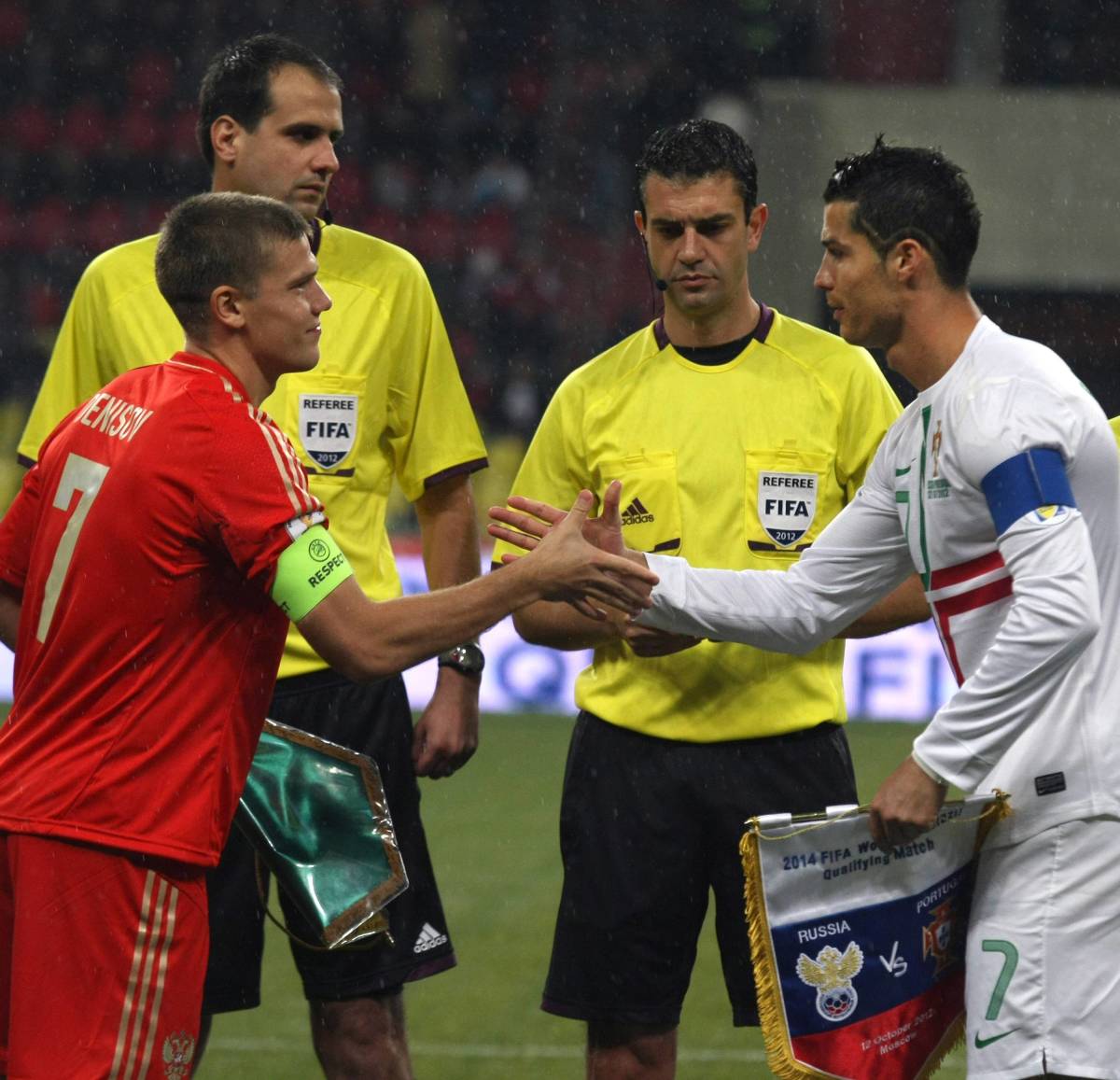 Russia captain Igor Denisov (left) pictured shaking hands with Portugal skipper Cristiano Ronaldo before a game in 2012