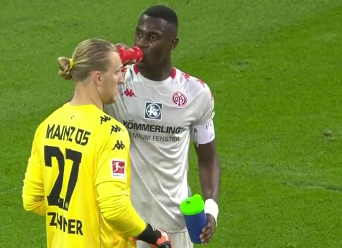 Mainz defender Moussa Niakhate pictured drinking to end his fast during Ramadan in a Bundesliga match against Augsburg