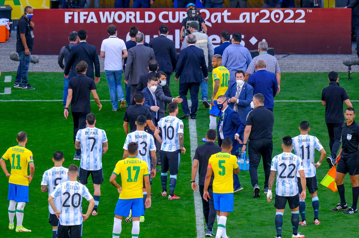 Players pictured leaving the field after Brazil vs Argentina was suspended in September 2021