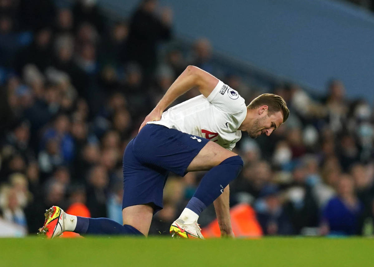 Harry Kane holds his back during Tottenham's 3-2 win at Man City in February 2022