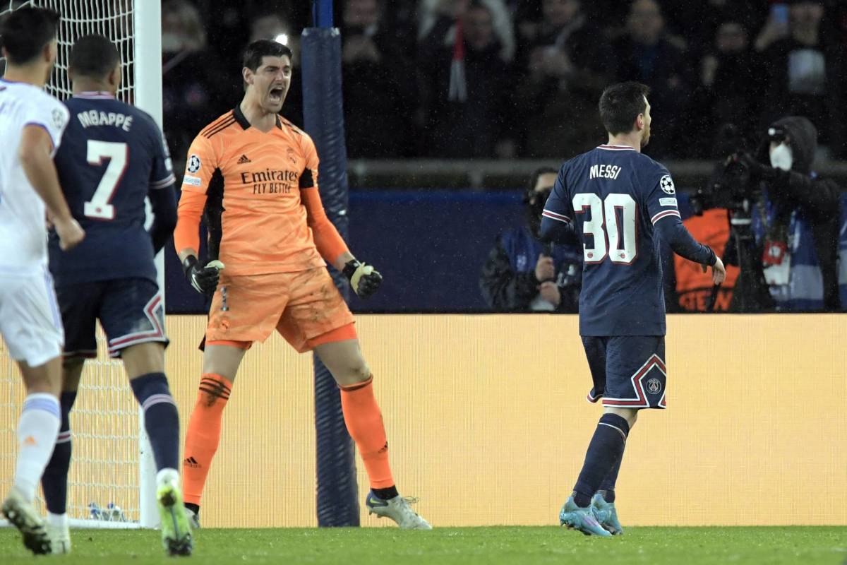 Real Madrid goalkeeper Thibaut Courtois celebrates after saving a penalty by PSG's Lionel Messi in February 2022