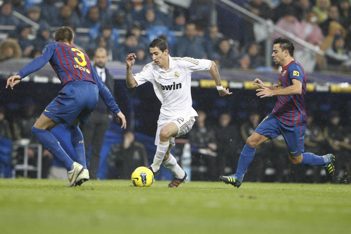 Angel Di Maria pictured (center) in action for Real Madrid against Barcelona in 2011