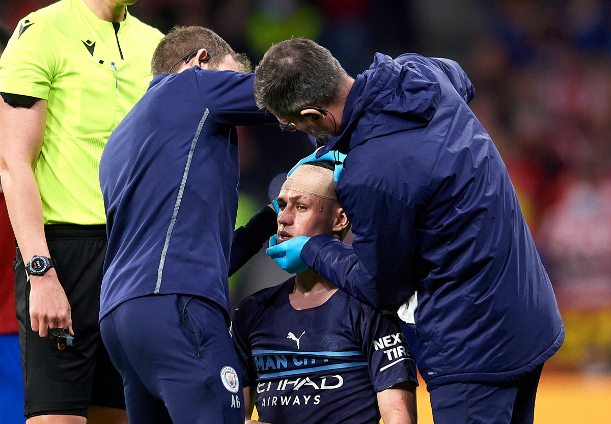Phil Foden is tended to by Manchester City medical staff following a clash with Atletico Madrid defender Felipe in April 2022