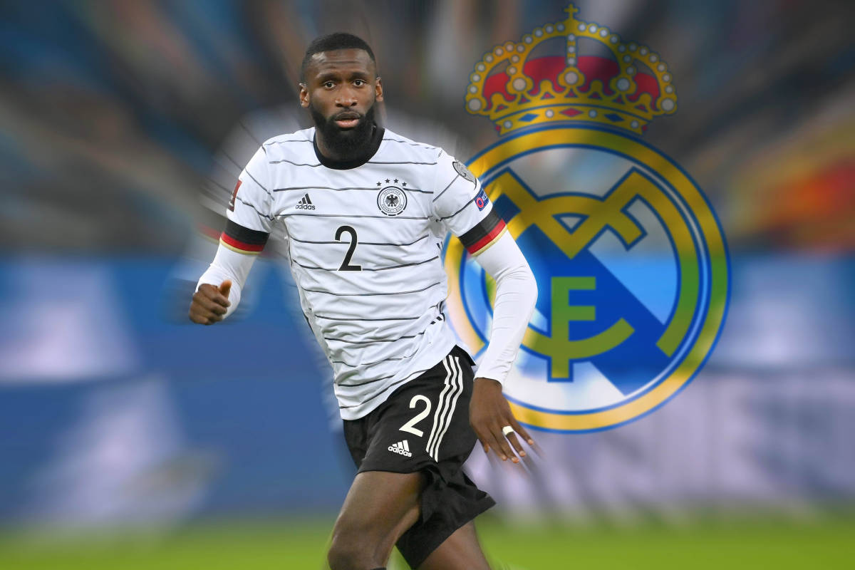 Antonio Rudiger pictured in Germany kit in front of a giant Real Madrid crest