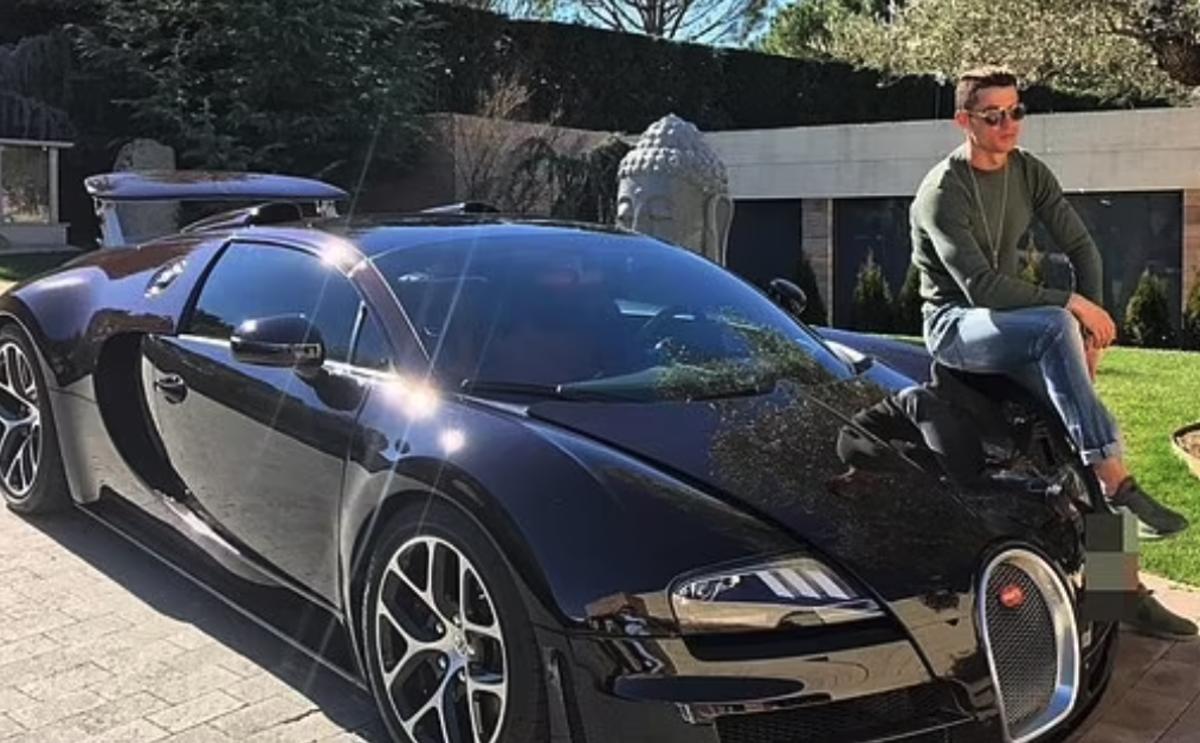 Cristiano Ronaldo pictured sitting on the bonnet of his Bugatti Veyron - before the car was crashed by one of his employees in Mallorca