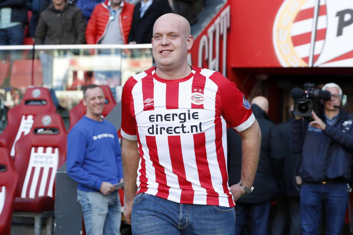 Darts player Michael van Gerwen pictured in a PSV Eindhoven shirt at a Dutch soccer match in 2019