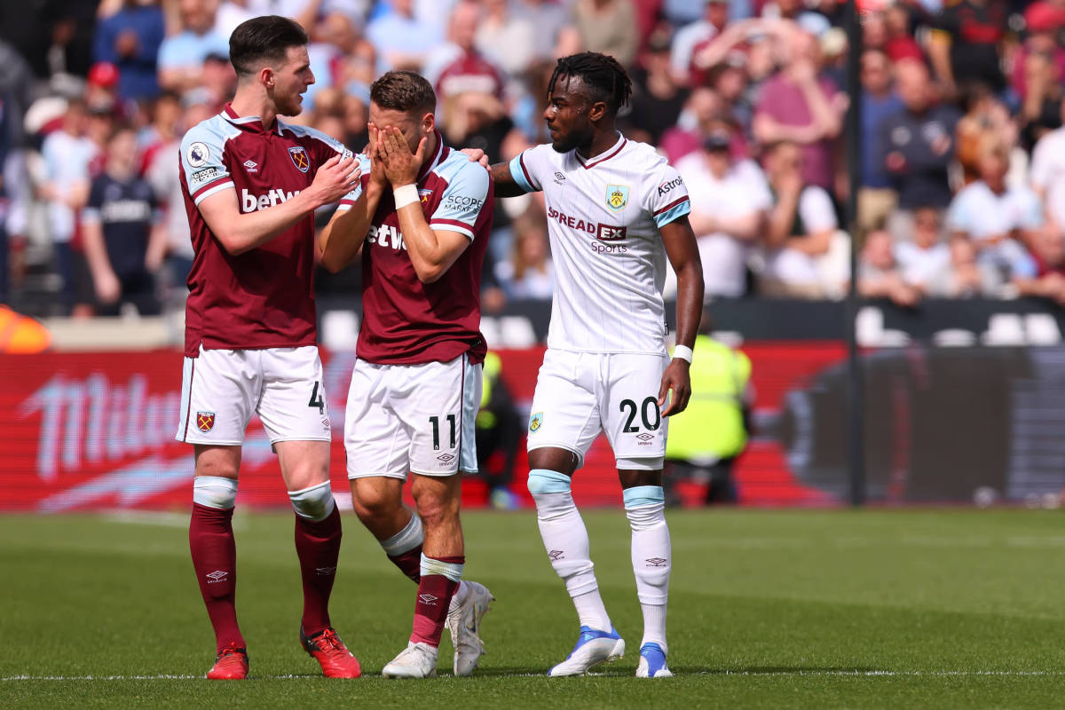 Nikola Vlasic (center) is consoled by Declan Rice (left) and Maxwel Cornet after being involved in Ashley Westwood's freak ankle injury during West Ham's Premier League game against Burnley