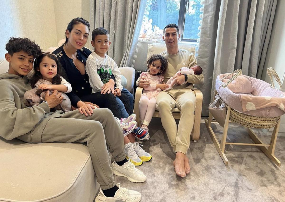 Cristiano Ronaldo pictured holding his new baby daughter as he sits alongside Georgina Rodriguez and their family